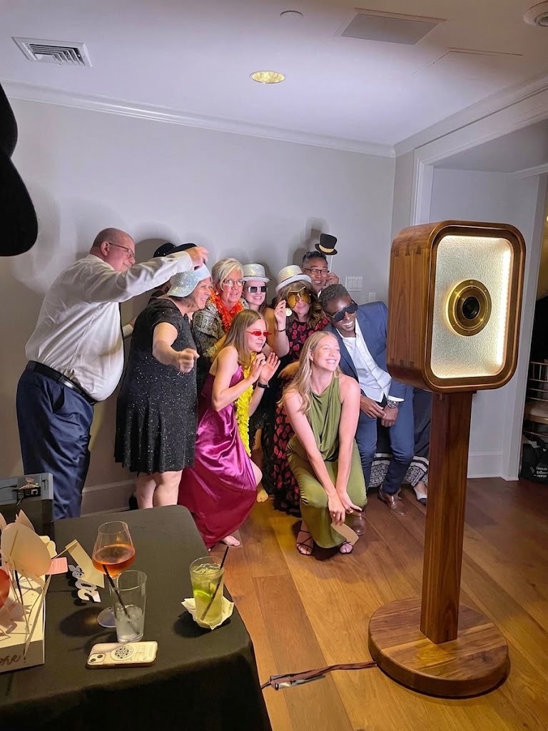PoseWithUs open-air wooden photo booth with guests celebrating at a Toronto event